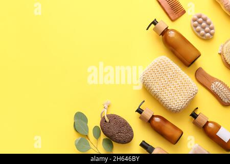 Set of bath supplies with loofah sponge and plant branches on beige ...