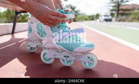 Close up view of a hands tying a skates in the street Stock Photo