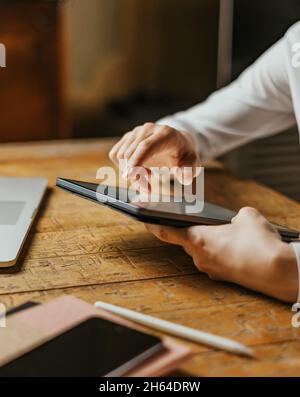 Close up photo of male hands tapping on digital tablet screen. Stock Photo