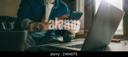 Man pointing on smartphone screen, chatting in social networks, meeting website, searching internet, sending sms, using text messenger or online banki Stock Photo