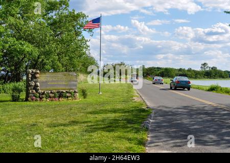 Old Greenwich, CT, USA-August 2020: View of the entrance of Greenwich Point Park or Tods Point with large sign next to road and American flag Stock Photo