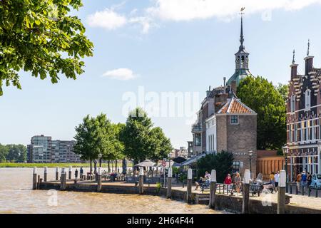 Dordrecht, the Netherlands-July 2021; View from the Kuipershaven towards the river, historic houses and the former city gate (groothoofdspoort) on a s Stock Photo