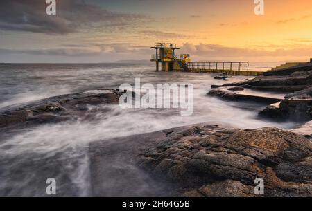 Beautiful seascape sunset scenery of Blacrock diving tower on Salthill beach in Galway city, Ireland Stock Photo