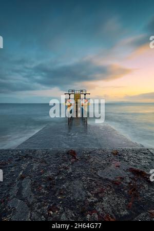Beautiful seascape sunset scenery of Blacrock diving tower on Salthill beach in Galway city, Ireland Stock Photo
