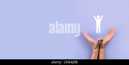 Male hand holding human icon on grey background. Human Resources HR management Recruitment Employment Headhunting Concept.Select team leader concept. Stock Photo