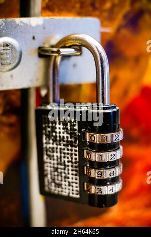 A combination digital pad lock keep a door locked in place. Stock Photo