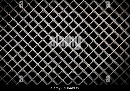 Iron ventilation grid lattice texture background. Silver gray metal pattern with square holes on black. Stock Photo
