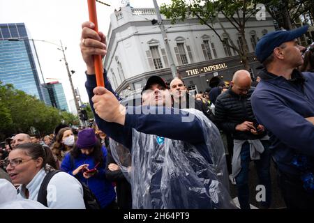 Melbourne, Australia. 13 November, 2021. A man is seen holding a flag during an anti Andrew's Government protest at the State Parliament steps in Melbourne. Thousands of protesters endured the rain to fight against vaccine mandates as well as the Andrews Governments draconian Pandemic Bill. Credit: Dave Hewison/Speed Media/Alamy Live News Stock Photo