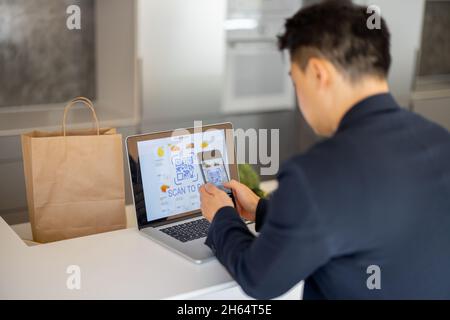 Man using smartphone for payment in online store Stock Photo
