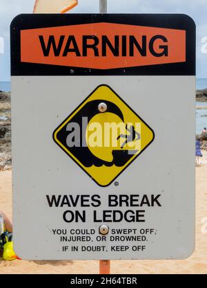 Beach Sign - Warning Waves Break on Ledge. Stock Photo