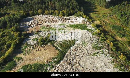 Aerial View Of Domestic Garbage Near Green Forest. Bird's-eye View Of Junk. Domestic Waste In Landfill Junkyard. Eco Concept Garbage Disaster From Stock Photo