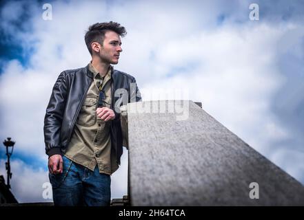 Attractive young man outdoor walking down stone stairs Stock Photo