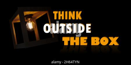 Think outside the box motivational message with a light bulb shining in a wooden box frame Stock Photo