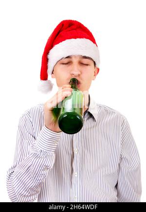 Young Man in Santa Hat drinks a Beer on the White Background Stock Photo