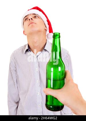 Young Man in Santa Hat refuse a Bottle of the Beer on the White Background Stock Photo