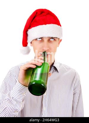 Young Man in Santa Hat drinks a Beer on the White Background Stock Photo