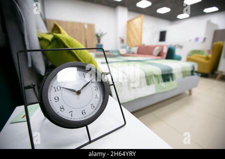 Alarm clock on the table in the bedroom. Stock Photo