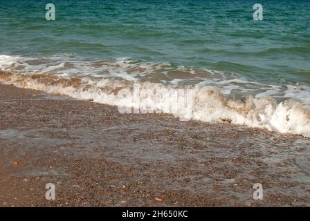 Soft sea wave beat on sandy shore closeup Stock Photo