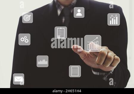 businessman touching digital business icon, network connection on modern virtual interface. Stock Photo