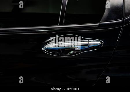 Modern black car door handle.Car door handle is an external part of the car. Stock Photo
