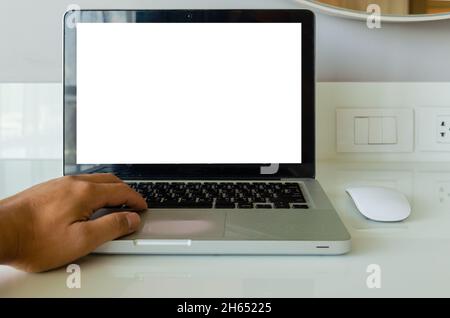 hand on keyboard computer laptop mock up and mouse white blank screen for advertising text on table. Stock Photo