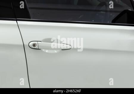 Modern white car door handle.Car door handle is an external part of the car. Stock Photo