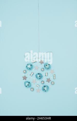 Christmas bauble made of various decoration elements on blue pastel background Stock Photo