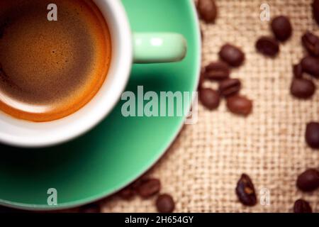 Close-up view of aromatic and fragrant coffee green cup and coffee beans. Coffee, beverage Stock Photo