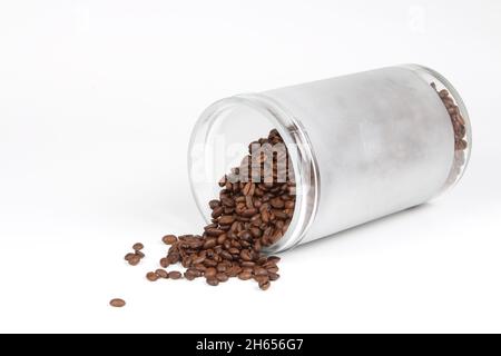 Close up of Coffee grains of nice smell out of a glass jar, isolated on a  white background Stock Photo