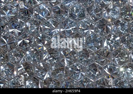 Close up on an highly detailed texture background depicting a luxurious surface adorned with gorgeous translucent diamonds and jewels shining and refl Stock Photo
