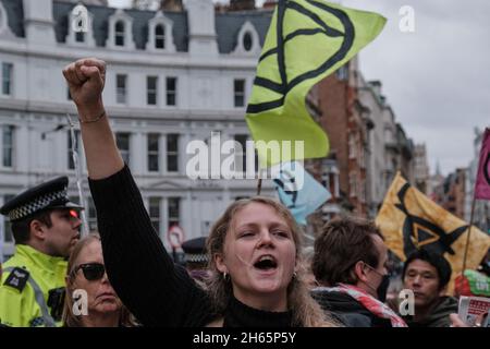 London, UK. 13th Nov, 2021. A young activist is chanting as Extinction Rebellion takes to the streets of London with the Rise and Rebel March to protest for the climate emergency, following COP26 summit. Credit: Chiara Fabbro/Alamy Live News Stock Photo