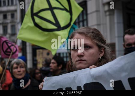 London, UK. 13th Nov, 2021. A young Extinction Rebellion's activist at the Rise and Rebel March to protest for the climate emergency, following COP26 summit. Credit: Chiara Fabbro/Alamy Live News Stock Photo