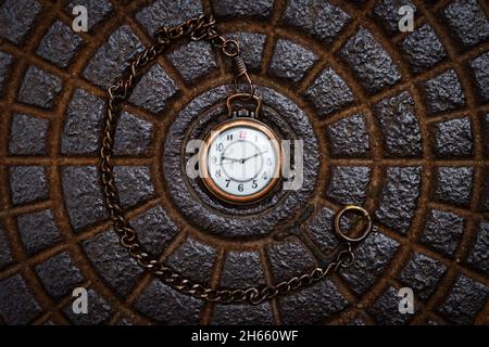 Pocket watch on metal texture background. Time concept. Retro clock face. Flat lay Stock Photo