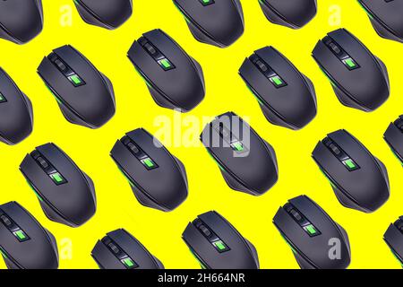 Wireless mouses, top view of wireless mouses isolated on yellow background. Computer equipments pattern background. Stock Photo