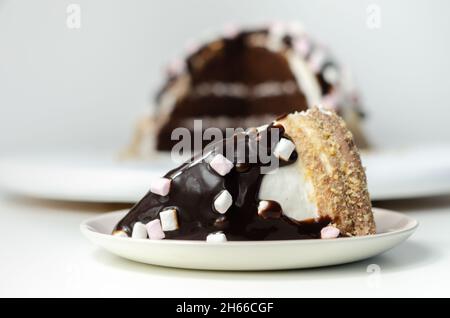 Chocolate sponge cake, coated and filled with marshmallow flavour frosting, chocolate flavour frosting, decorated in the digestive crumb with chocolat Stock Photo