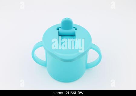 https://l450v.alamy.com/450v/2h66hbw/toddlers-no-spill-sipping-cup-in-blue-with-handles-isolated-on-white-background-with-copy-space-2h66hbw.jpg