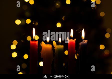 Candlelight Day. Traditional Colombian holiday. Group of colored candles lit at night with unfocused lights in the background. Copy space. Stock Photo