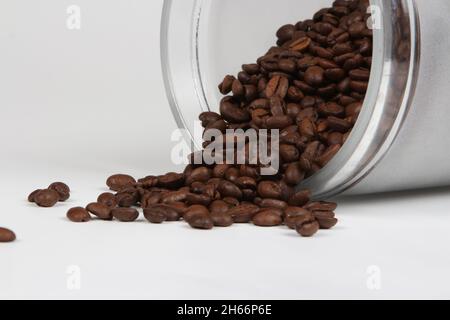 Close up of Coffee grains of nice smell out of a glass jar, isolated on a  white background Stock Photo