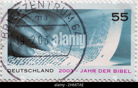 GERMANY - CIRCA 2003:  a postage stamp from Germany, showing some book pages about the year of the bible Stock Photo