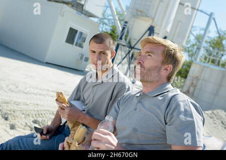 modern building business and workers having lunch outdoors Stock Photo