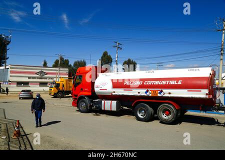 Senkata, El Alto, Bolivia. 13th November 2021. A fuel tank truck with 'Danger Fuel' in Spanish painted on the side of the tank waits outside the Senkata Fuel Plant on Av 6 de Marzo / Camino Oruro in El Alto. Yacimientos Petrolíferos Fiscales Bolivianos (YPFB, Bolivia's state owned petroleum / hydrocarbons company) have a large refinery and storage plant here: it is also the distribution centre for supplying La Paz, El Alto and the surrounding area. Stock Photo