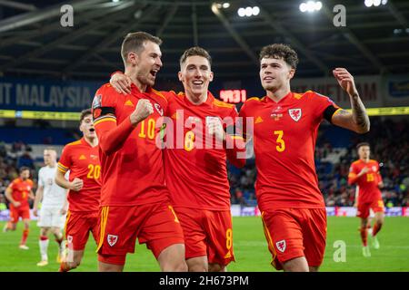 Cardiff, Wales, UK. 13th Nov, 2021. Aaron Ramsey of Wales (left) celebrates scoring his side's third goal with Harry Wilson and Neco Williams during the World Cup 2022 qualification match between Wales and Belarus at the Cardiff City Stadium. Credit: Mark Hawkins/Alamy Live News Stock Photo