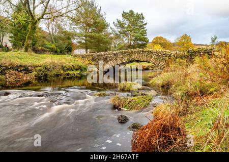 Stone footbridge over Watendlath Beck at Watendlath Tarn in the Lake District in Cumbria, England Stock Photo