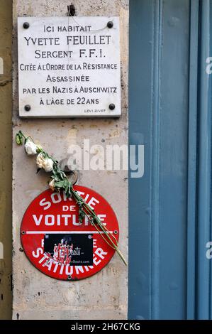A memorial plaque marks the Paris residence of Yvette Feuillet, a member of the French resistance during World War II who was killed by the Nazis. Stock Photo