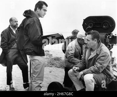 Director JOHN FRANKENHEIMER holding script and Cinematographer JAMES WONG HOWE looking through view finder of Movie Camera on set location candid with Film Crew during filming of SECONDS 1966 director JOHN FRANKENHEIMER novel David Ely screenplay Lewis John Carlino  music Jerry Goldsmith Joel Productions / John Frankenheimer Productions Inc. / Gibraltar Productions / Paramount Pictures Stock Photo