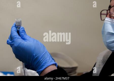 London, UK. 13th Nov, 2021. A NHS health worker prepares to administer Covid-19 booster jab to a woman at a vaccination centre. (Credit Image: © Dinendra Haria/SOPA Images via ZUMA Press Wire) Stock Photo