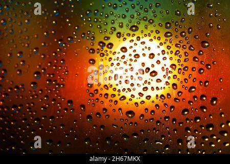 Drops at glass in gradient light . Condensation on the transparent surface . Rainy season in night Stock Photo