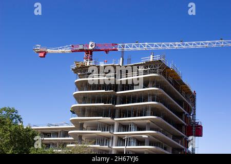 Large Crane On Top Of New Building Under Construction Stock Photo