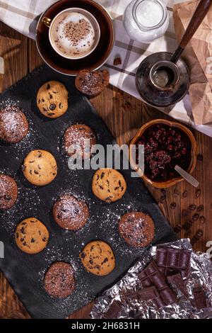 Cookies with chocolate and coffee on a wooden table, flat lay, top view Stock Photo