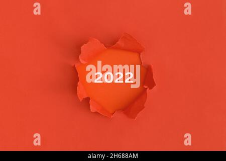 Red torn paper with text 2022 with red background. Christmas concept Stock Photo